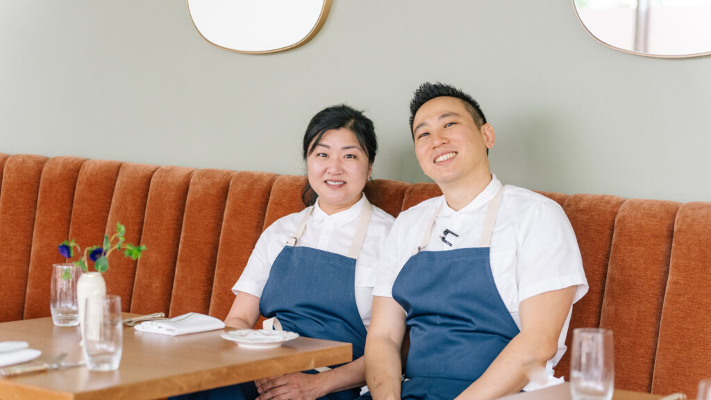 Two chefs sitting on a banquette