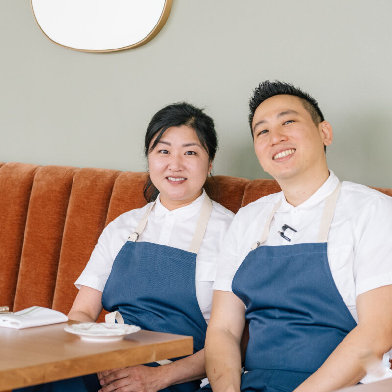 Two chefs sitting on a banquette